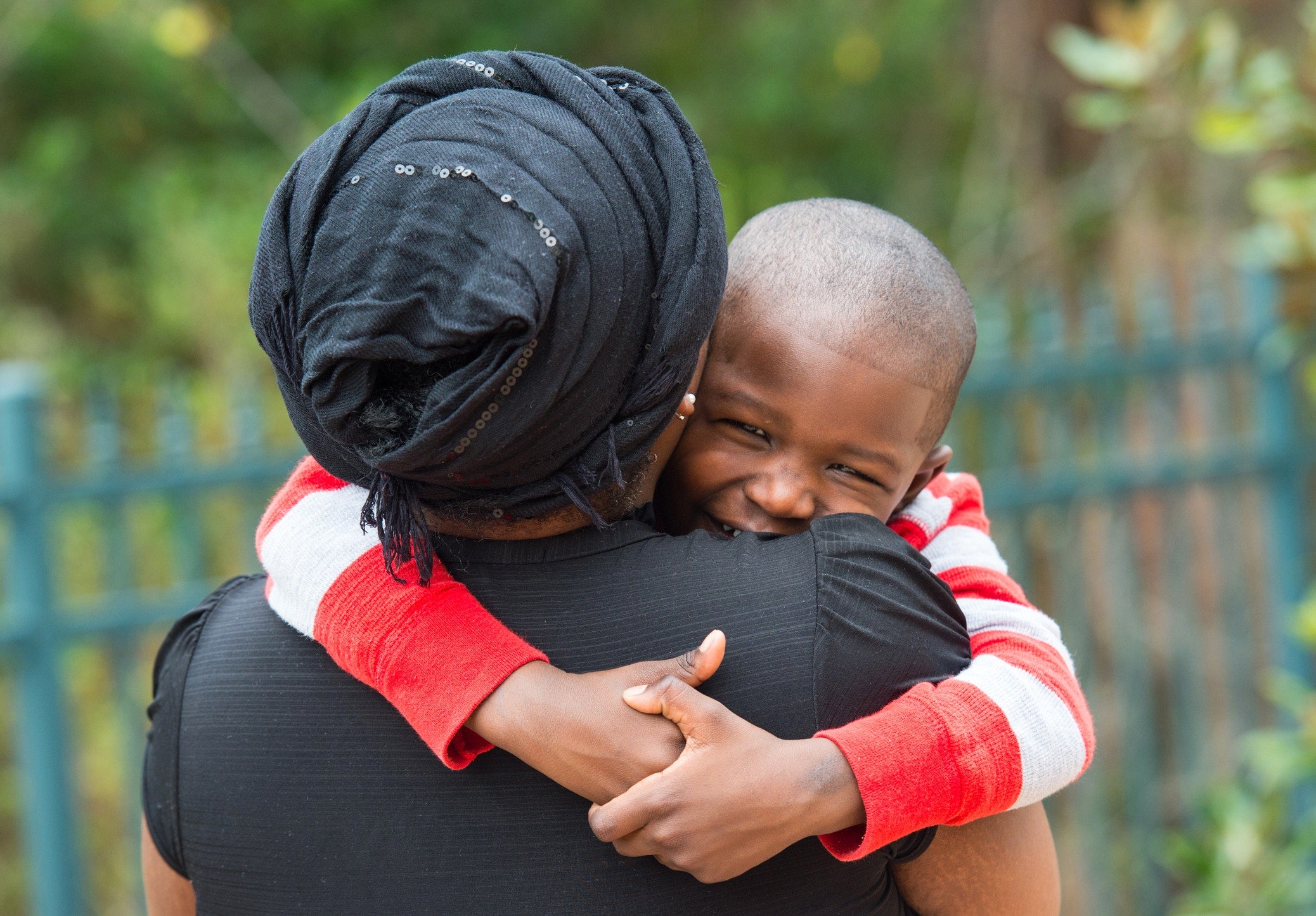 mother holding her happy son in her arms