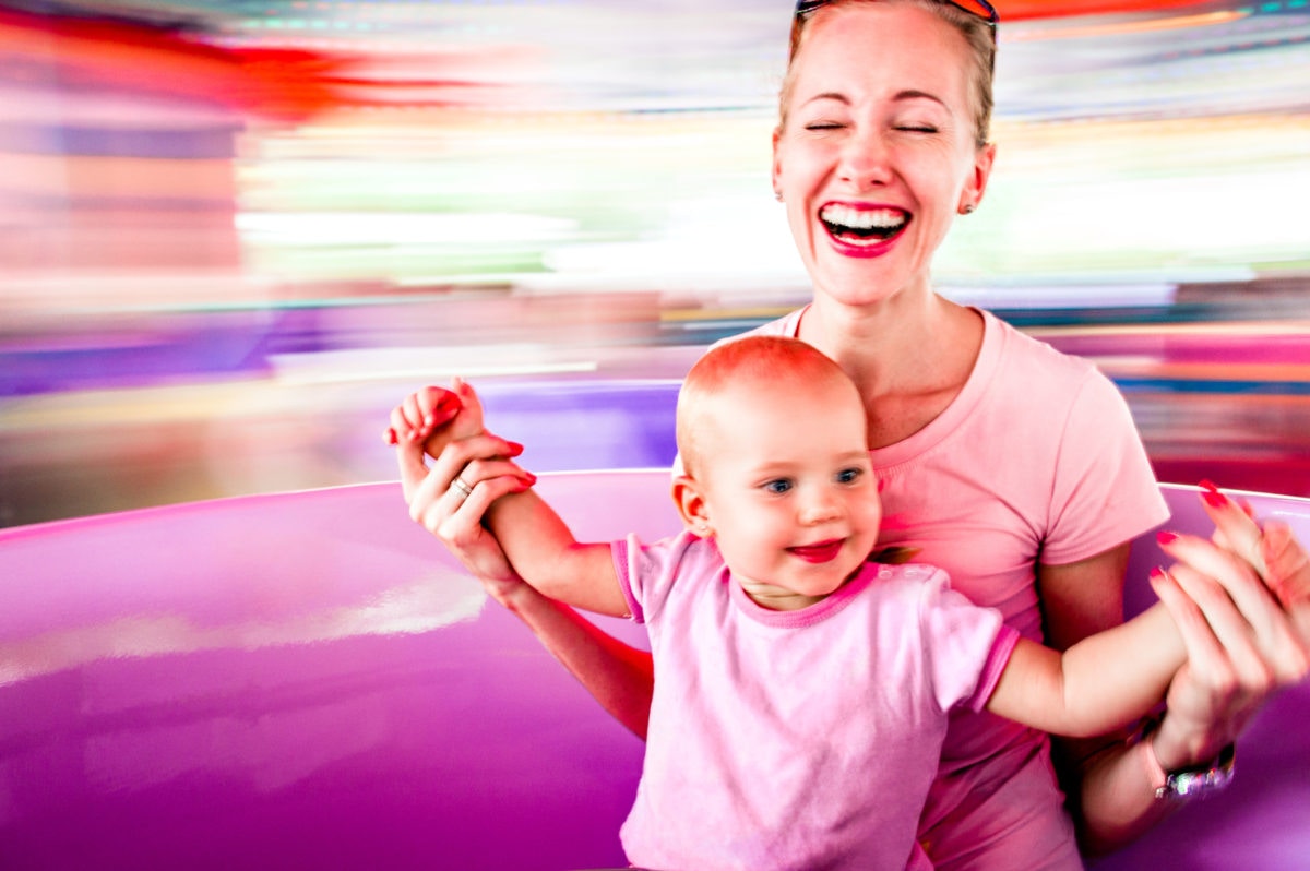 women laughing with her baby