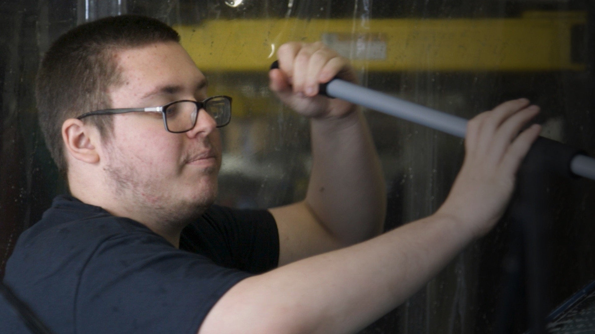 A person is cleaning glass