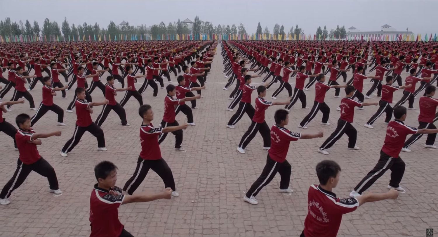 asian people doing exercises outside