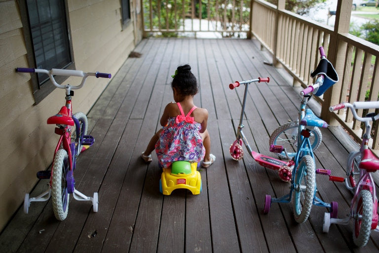 baby girl riding a toy bike