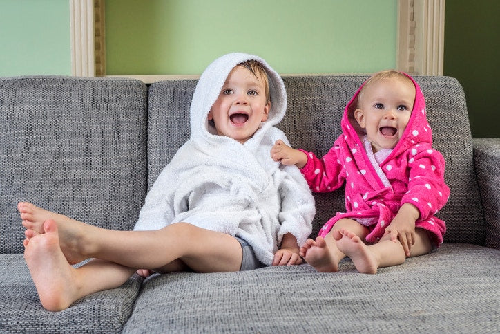 Two children sitting on a couch