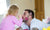 little girl applying lipstick on her father 