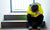 young boy sitting on the stairs in a closed position with his head down is feeling stressed