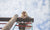 Young girl standing at top of ladder in playground