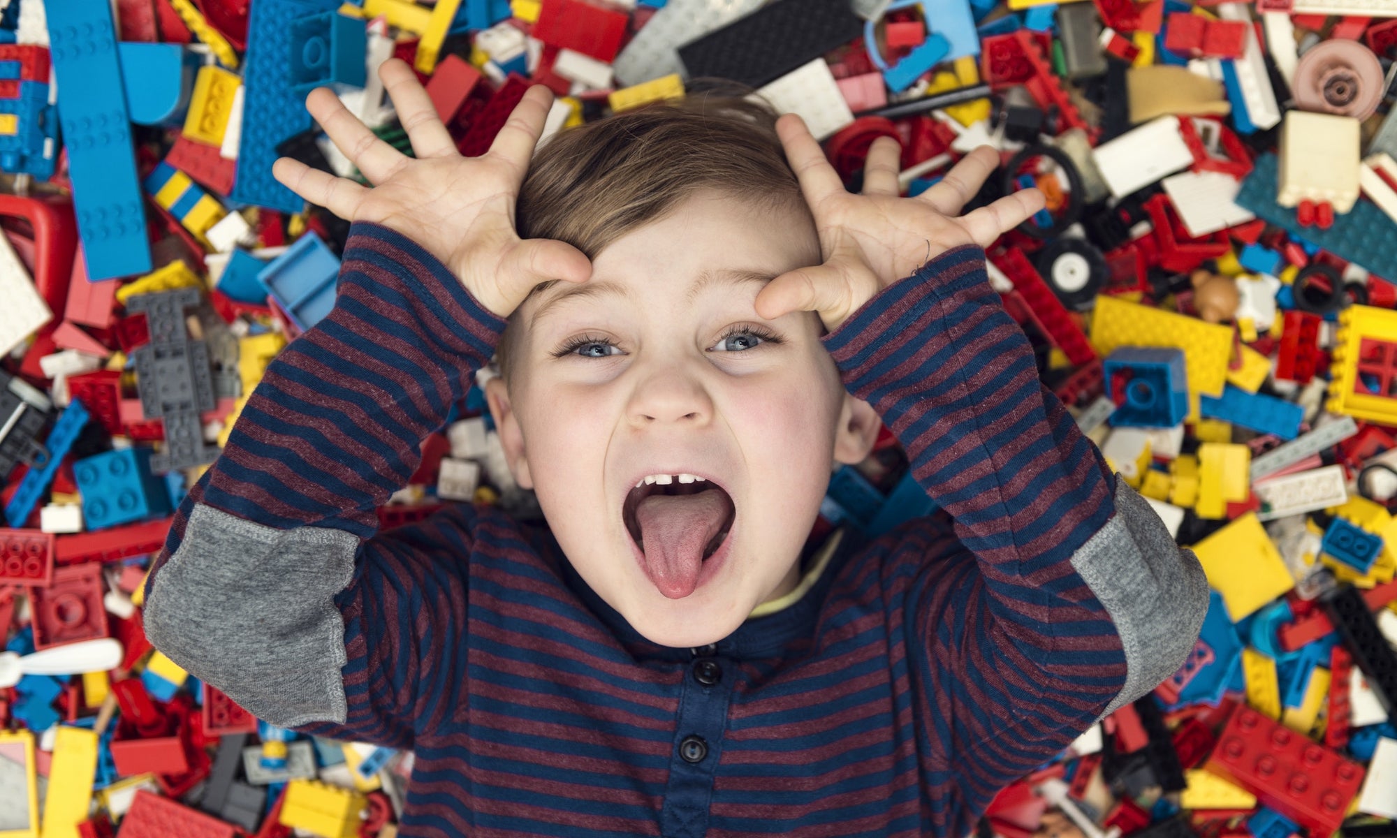 Playful boy between plastic blocks