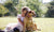 Girl hugging a big dog in a field