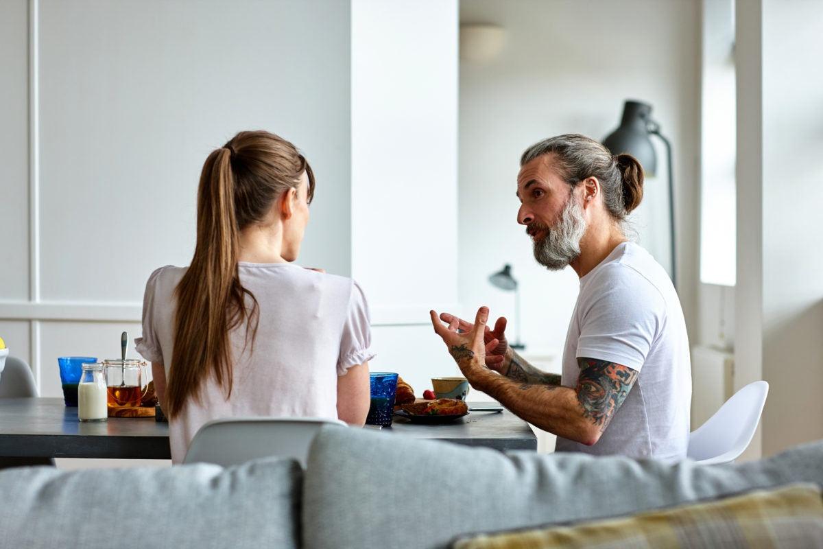 Two person is doing conversation in a dining hall