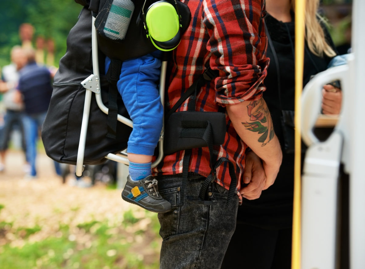 dad carrying baby on his back 