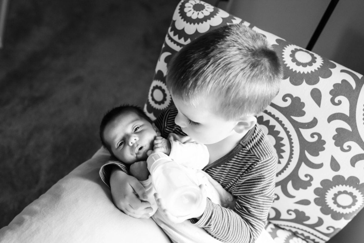 big brother bottle feeding little brother