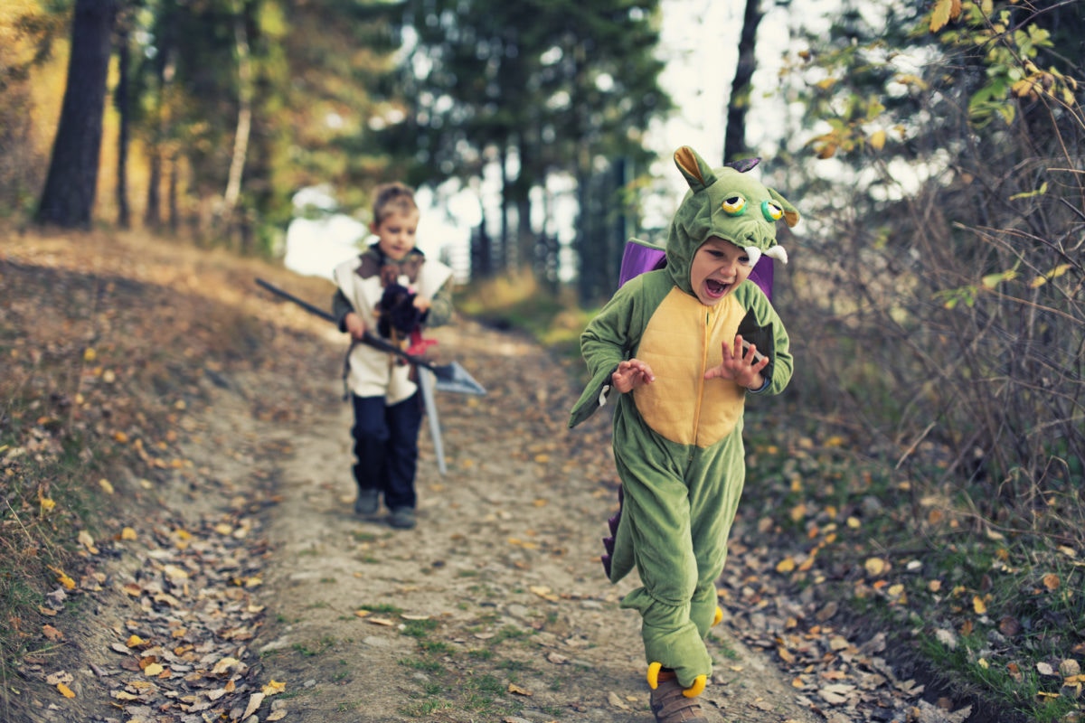 young  happy girl wearing dragon costume