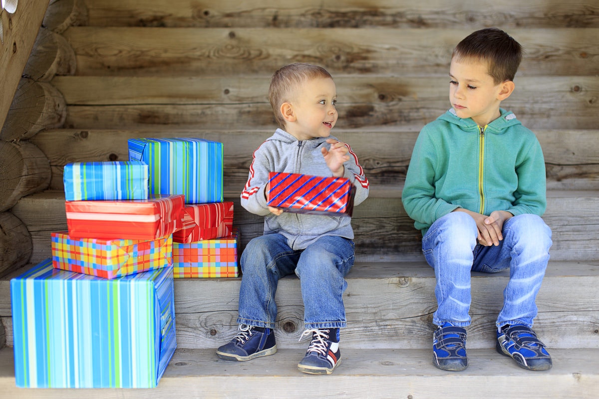 envious elder brother is jealous of a pile of gifts that are gifted to younger brother