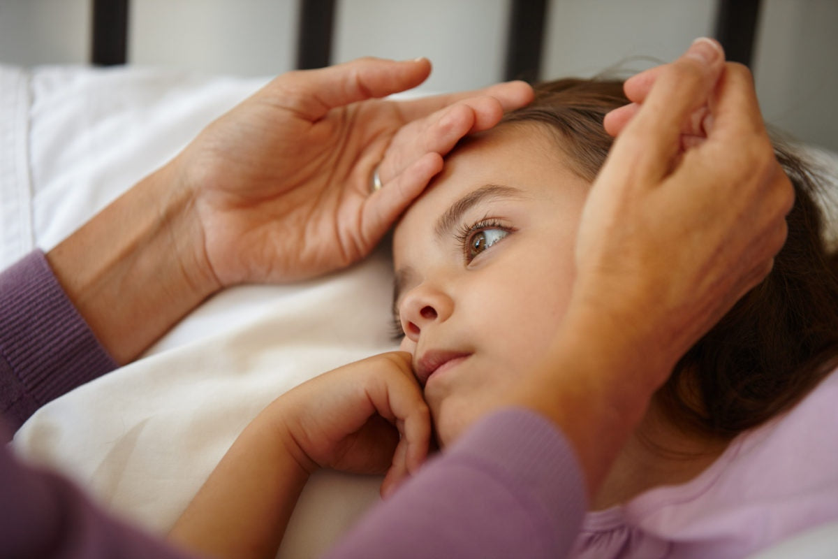 Mother checking body temperature of her daugther with her hands