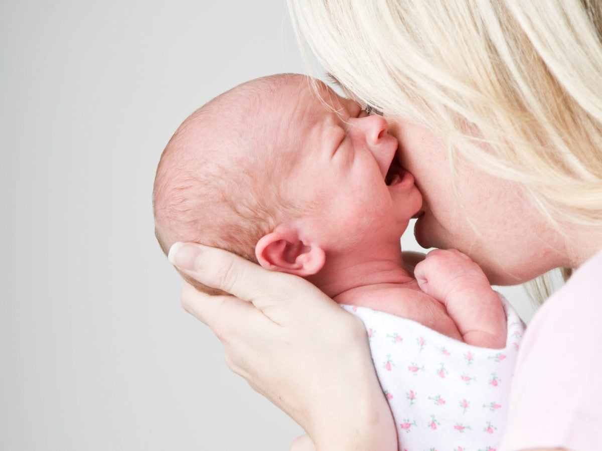 Mother holding crying newborn baby