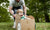 dad pushing a young boy in a cardboard car box