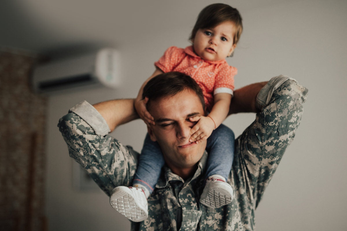 man with child on shoulders