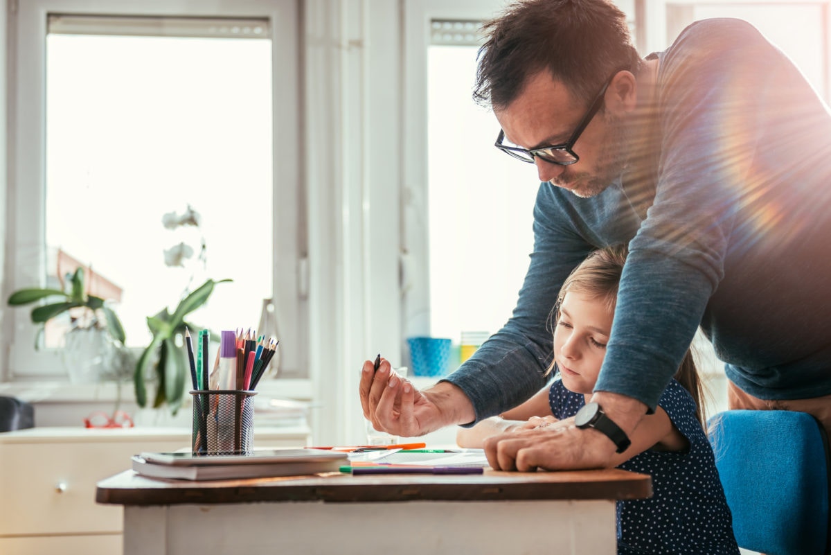 father helping daughter with her homework