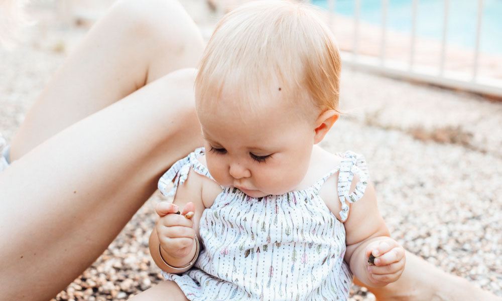 baby looking at rocks