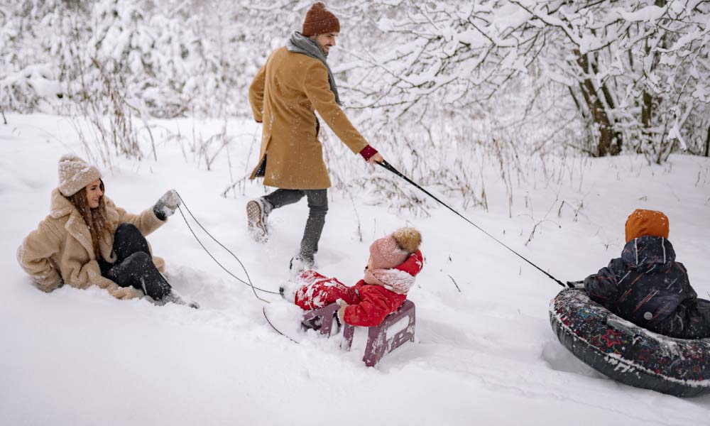 family playing in the snow