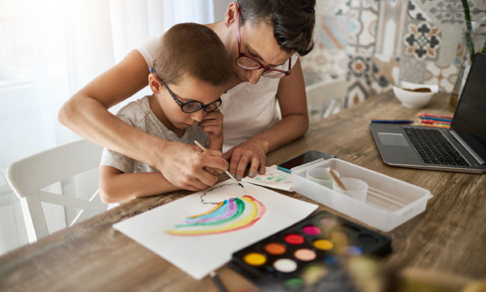 father and son painting a rainbow