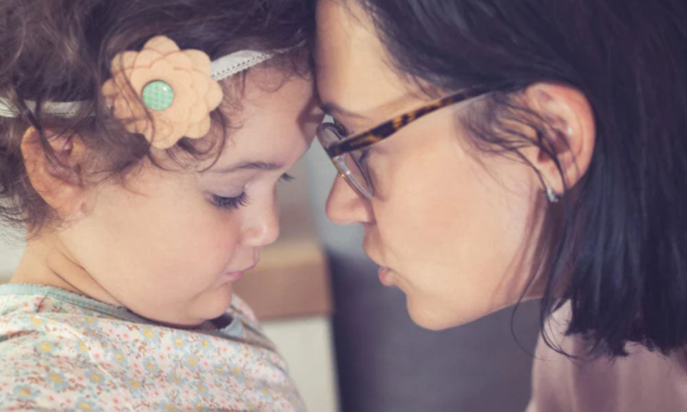 mom and child touching forehead