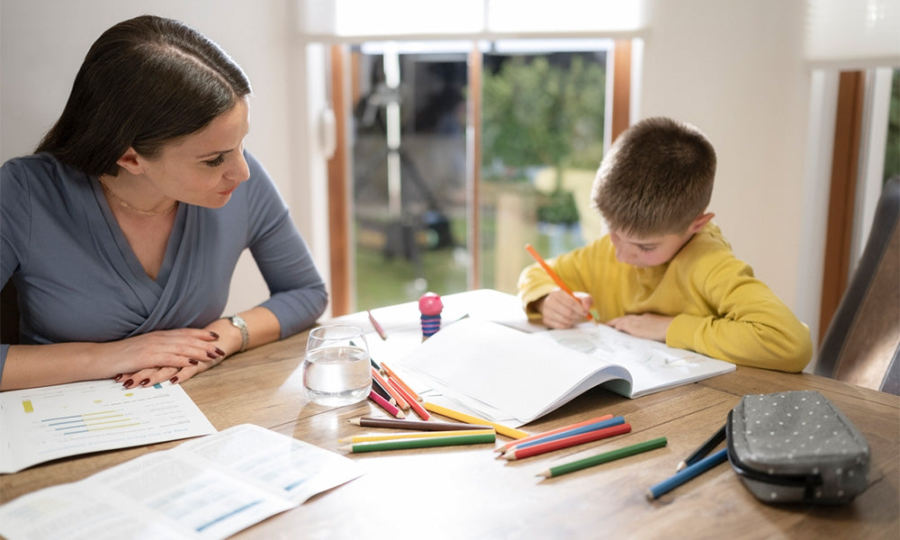 mother doing homework with son