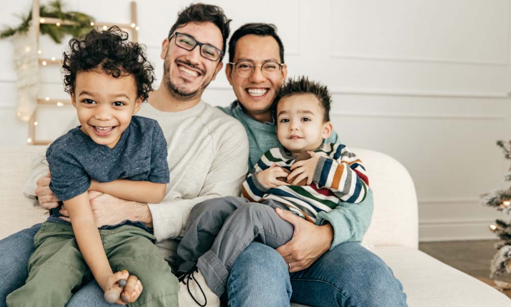 two kids and two dads smiling